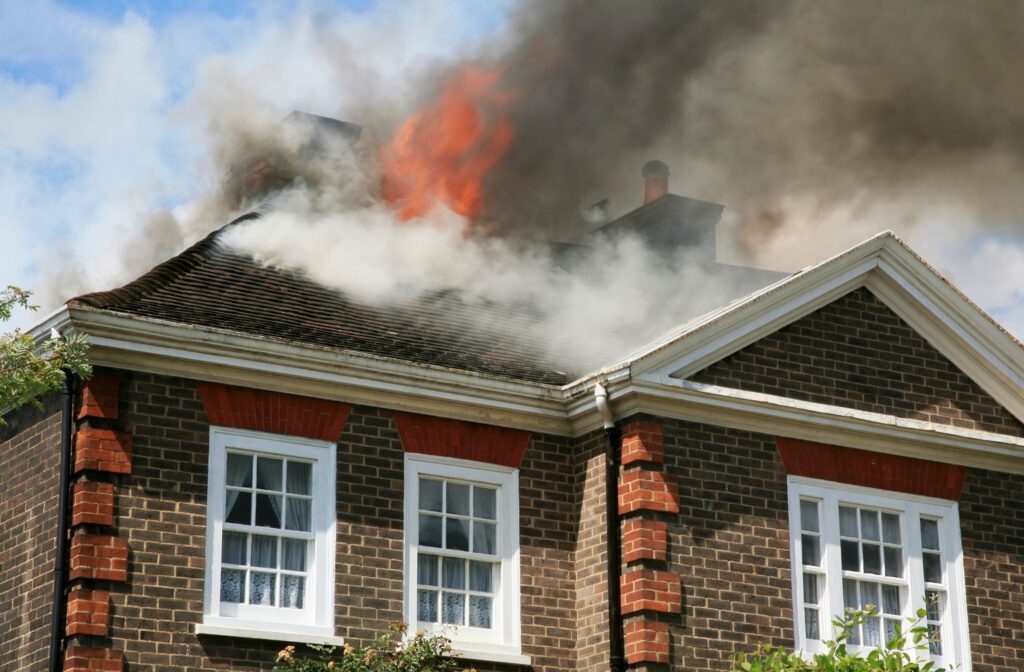 House fire with smoke and flames on roof