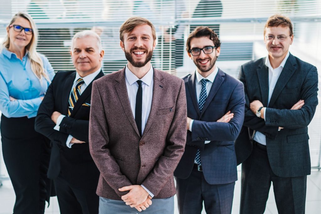 Five business professionals smiling in office
