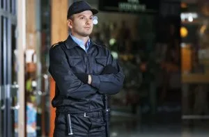 Security guard standing with arms crossed in mall