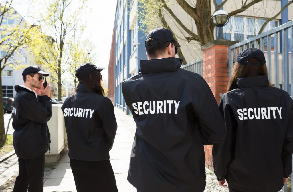 Three security officers patrolling in urban setting